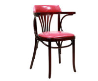 A wooden chair with a red leather seat