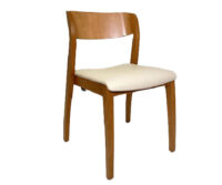A wooden chair with a white seat cushion