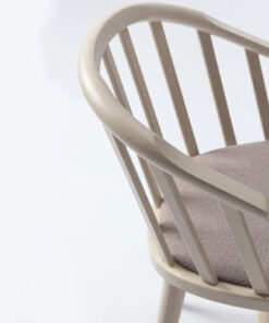 A white chair with a gray cushion on it