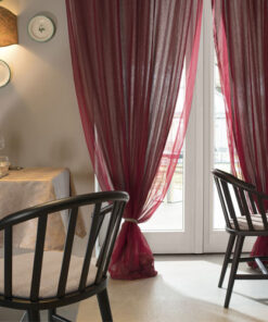 A dining room with two chairs and a table