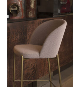 A bar stool with a beige upholstered seat